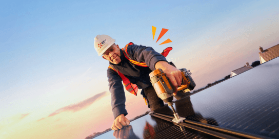 edf electrician drilling a solar panel on a roof
